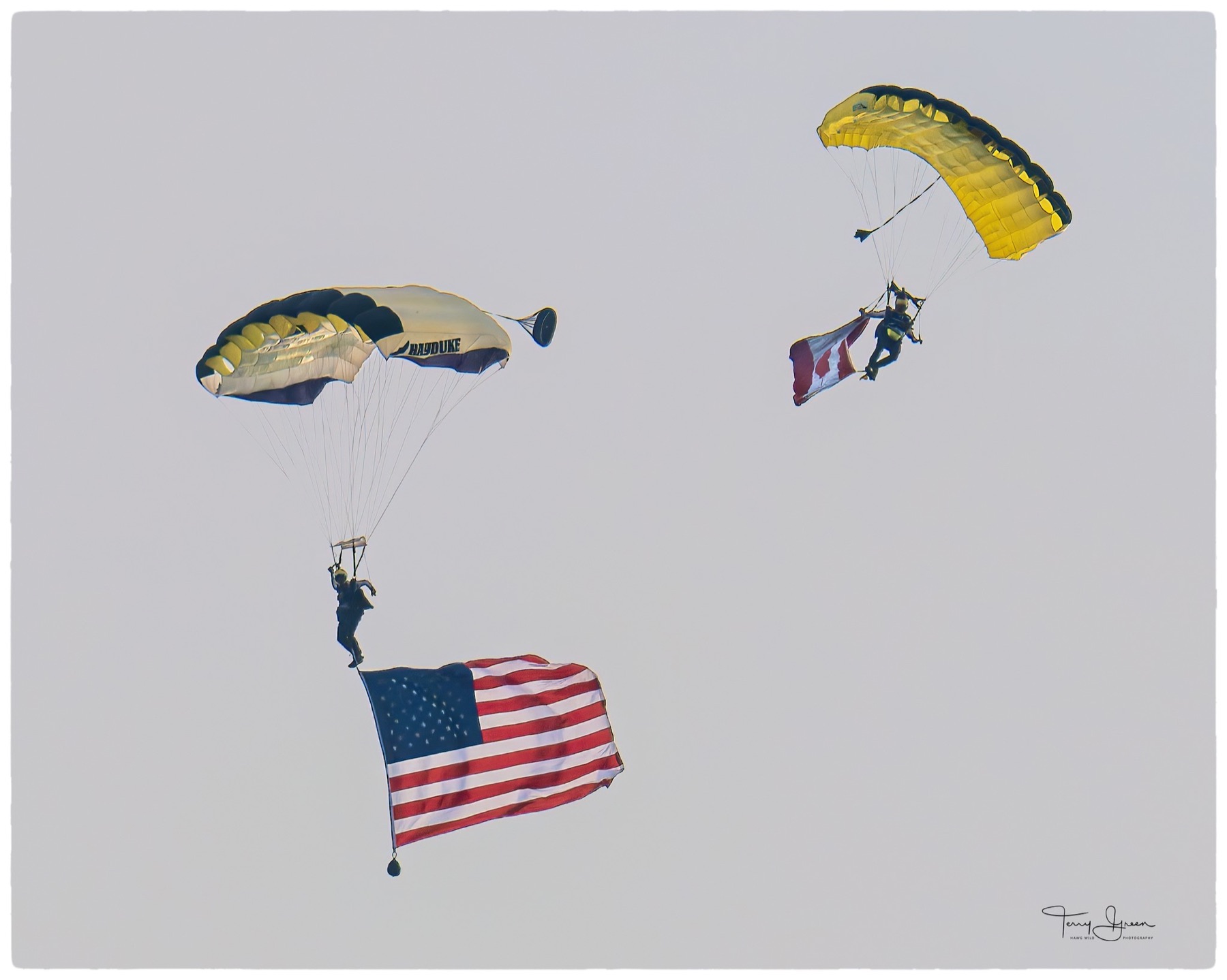 Two parachutists flying large flags