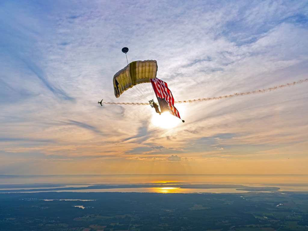 Flag jump at sunset with smoke in the distance