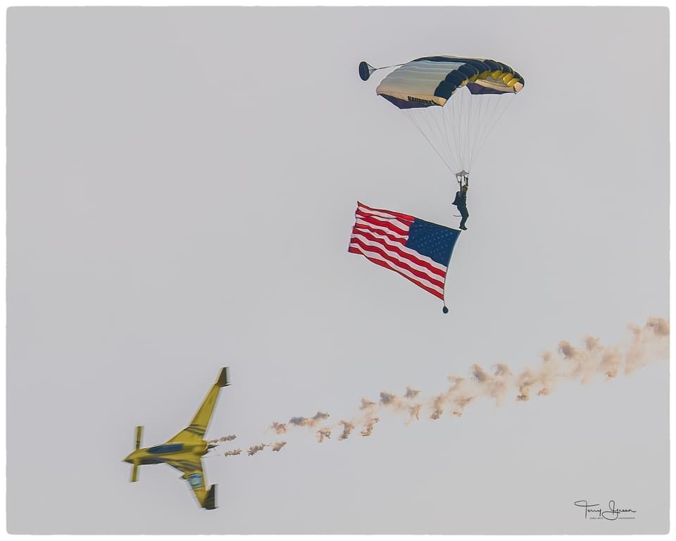 American flag parachute demonstration with aircraft smoke