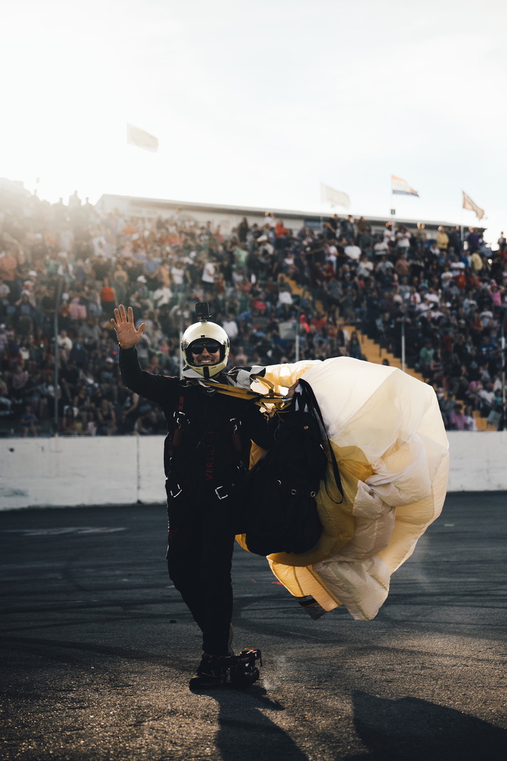 Skydiver waving to the crowd after landing